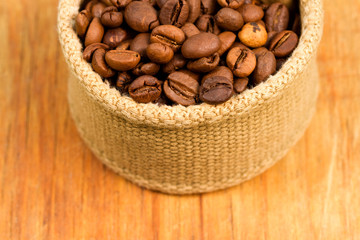 Coffee beans in fabric on a wooden