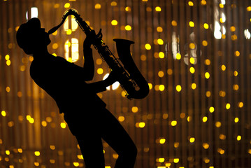 Saxophonist. Woman playing on saxophon
