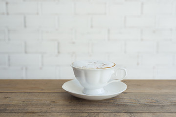 Hot cappuccino on wood background