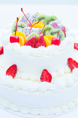 White wedding cake topped with fruit. Selective focus