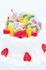White wedding cake topped with fruit. Selective focus