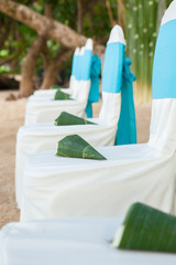 floral arrangements located on seats at a wedding ceremony