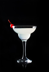 Cocktail in margarita glass on the wooden background
