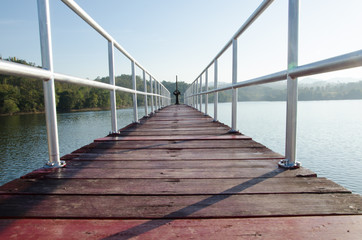 Fototapeta premium Bridge embankment in the morning with mountains in the backgroun