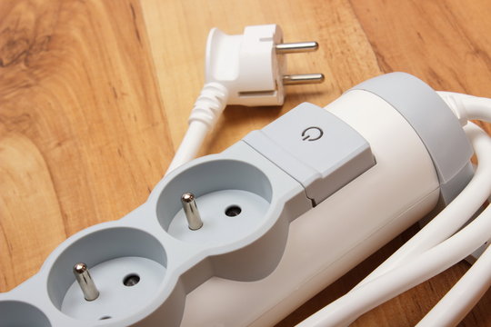 Electrical power strip with switch on-off on wooden floor