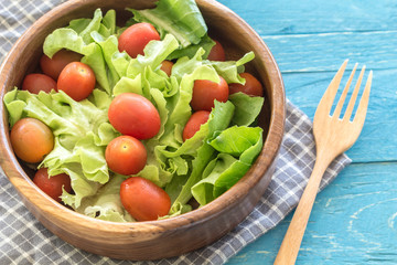 healthy salad with tomatoes on wooden table