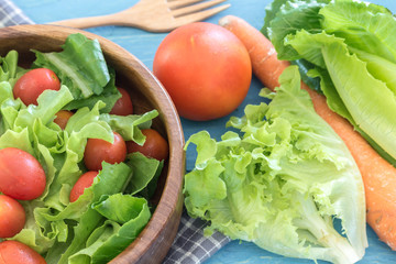 healthy salad with tomatoes on wooden table