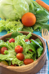 healthy salad with tomatoes on wooden table