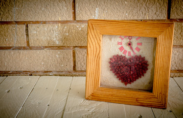 Photo frame on wooden table over wall background - Still life an