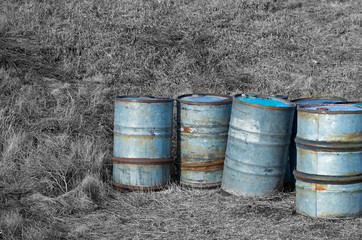 fuel drums on a background of black and white grass