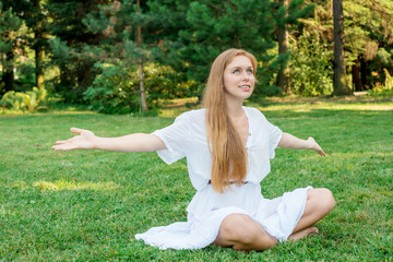 Woman with long hair engaged in yoga on the nature