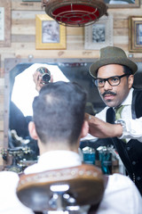 Portrait of stylish barber with moustache working