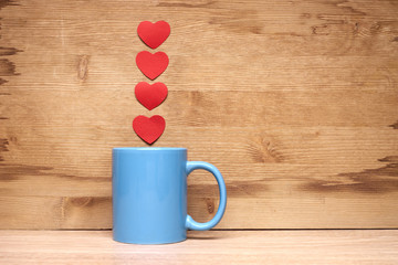 Heart and cup on a wooden background