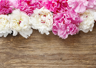 Stunning pink peonies, yellow carnations and roses on rustic woo