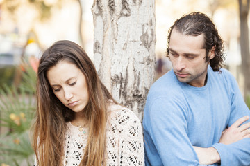 Couple are upset with each other outdoors