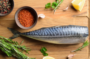 fresh raw mackerel on wooden background, top view