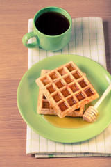 Traditional belgium soft fresh waffles with a honey. Toned