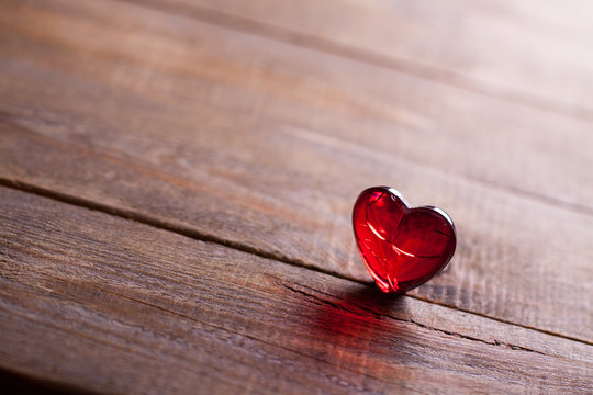 Red heart on wooden background. Symbol of love in valentine's day.