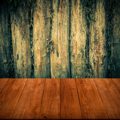 The wall of the old logs. Background. View from dark wooden gang