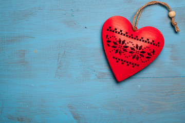 Red heart on blue wooden background. Symbol of love in valentine's day.