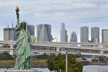Statue of liberty and skyscraper in Odaiba, Tokyo, Japan.