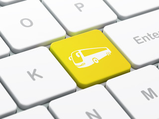 Tourism concept: Bus on computer keyboard background