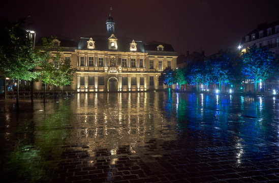 City Hall in the rain at night in Troyes, France .