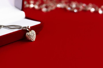 luxury heart necklace with stylish diamonds on red background, p