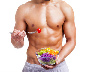 Fit man holding a bowl of fresh salad on white background