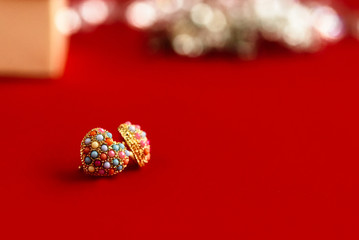 stylish luxury heart earrings with colorful gems on white backgr