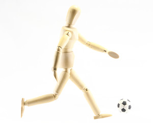 Wooden puppet playing football