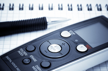 Journalist equipment. Digital voice recorder, pen, notebook