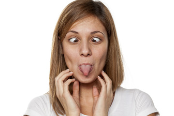 Fototapeta premium funny young woman without make-up with tongue out