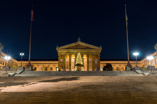wide point of view of Philadelphia Museum of Art stairs at night with Christmas tree