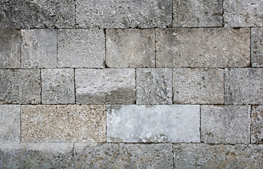 The wall of an old fortress in Rhodes old town , Greece.