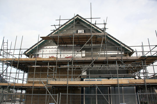 A house under construction with scaffolding