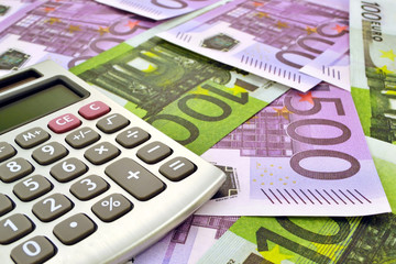 Photo of calculator with money 100 and 500 euro