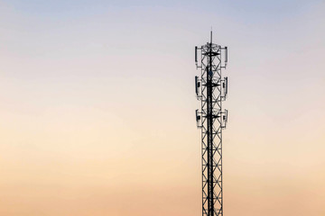 Telecommunication cellular tower on twilight background. Used to