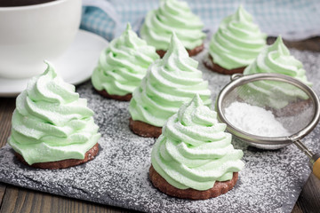 Homemade apple zefir fir-tree, placed on chocolate cookie and decorated with sugar balls