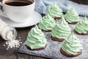 Homemade apple zefir fir-tree, placed on chocolate cookie and decorated with sugar balls