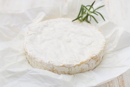cheese with rosemary on white paper