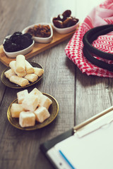 Dried fruits, Turkish delight, lokum and Arab headscarves on the table.