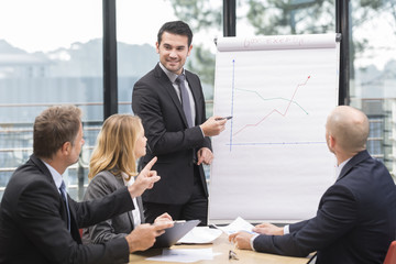 Businessmen are meeting near the flipchart