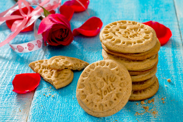 Biscuits with honey and cinnamon on Valentine's Day and a red ro