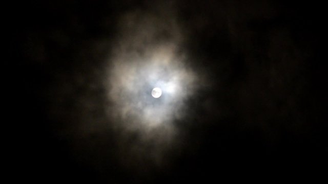 Stormy weather in the night with full moon, dramatic clouds, rushing