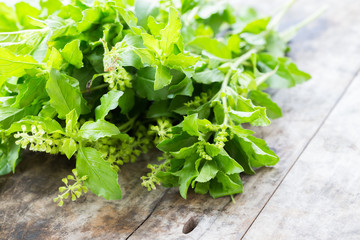 Basil leaf on wooden table