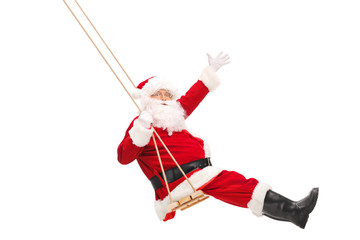 Santa Claus swinging on a wooden swing