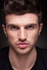 Obraz premium Stylish guy close up portrait on black background