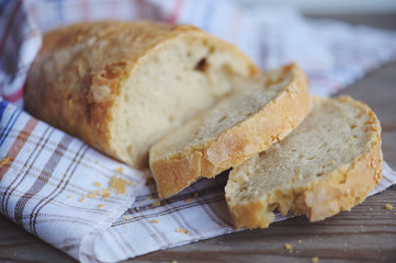 Fresh baked bread with seeds on rustic wooden background