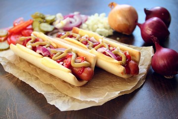 Hot dogs with onion, cheese, mustard and ketchup